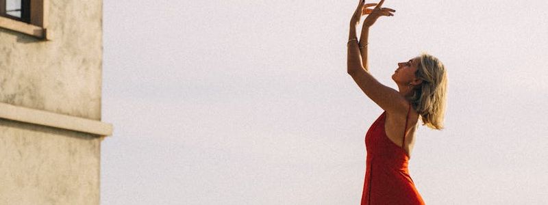 Silhouette of a person balancing during sunset.